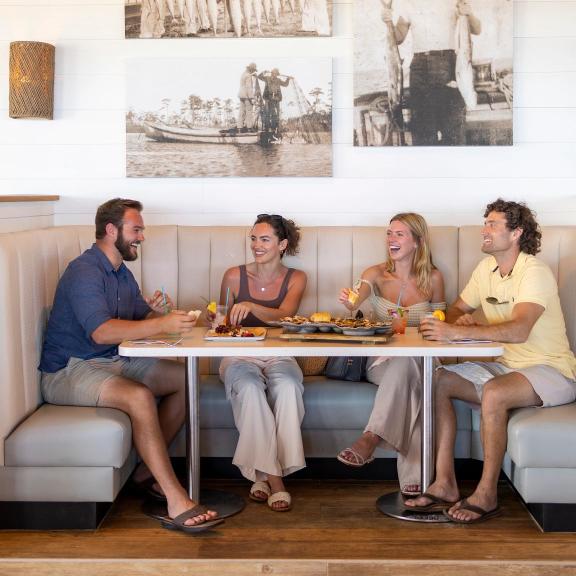 Friends dining at Coastal beachfront restaurant in Orange Beach